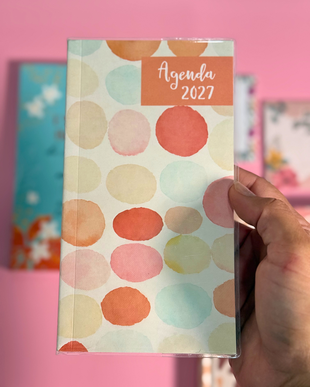 Agenda Pocket 2027 acuarela sostenida en la mano para mostrar su tamaño de bolsillo